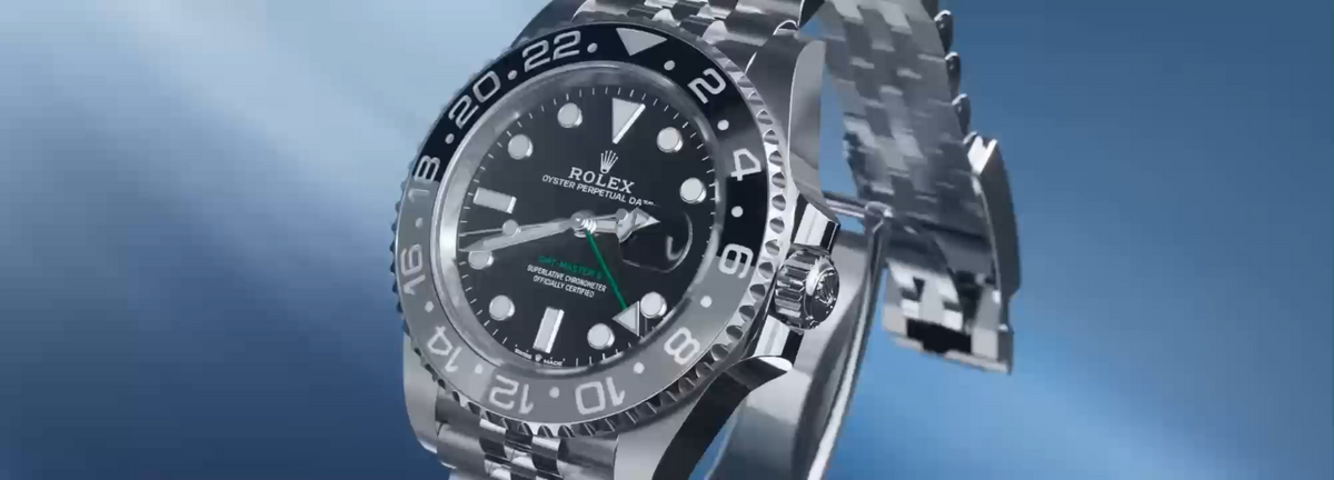 Polished steel watch against a cool blue background